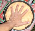flatten the dough using your hands, to release the air