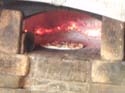 pizza baked in a wood-burning brick oven