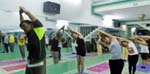 conducting a yoga class at the Mai Chi Yoga Dance studio