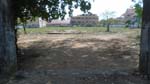 a fenced vacant lot with an open gate - guess what? no squatters!