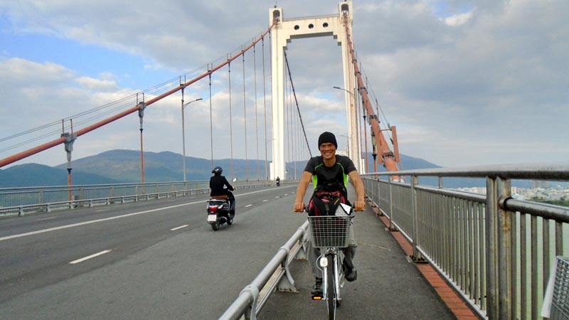 on the Thuan Phuoc Bridge on a bike