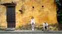 Tuyen and I by the wall of a preserved building in Hoi An, Vietnam