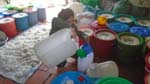 rice wine is transfered to big plastic jugs for resale
