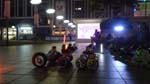 at night on an outdoor setting by a mall, roller blades and hover boards can be rented - MYR10 for blades