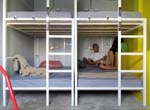 the bunk beds are separated from each other by a plywood wall