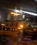 a reflection of the Petronas Towers from a bus window