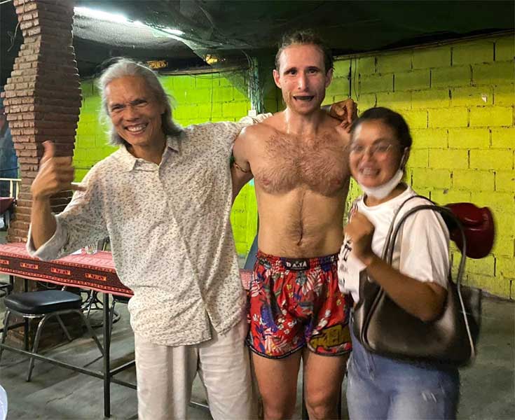 hamming it with the triumphant Muay Thai warrior